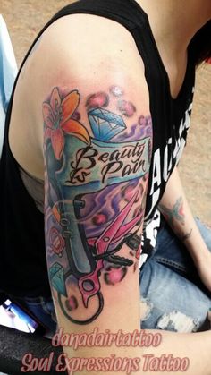 a woman with a tattoo on her arm and the words beauty is born written in cursive writing