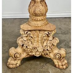 an ornately carved wooden pedestal on the floor