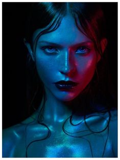 a woman with blue and red light on her face