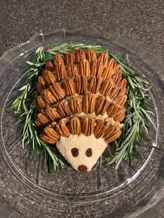 a hedgehog made out of crackers sitting on top of a glass plate