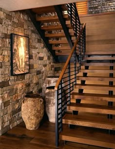 there is a stone wall and stairs in this room with wood flooring on both sides