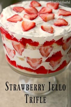 strawberry jello trifle with whipped cream and strawberries in the middle on top