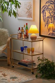 a table with drinks on it next to a lamp