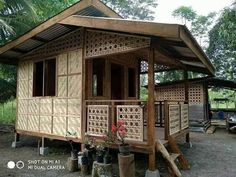 a small house made out of wood and bamboo