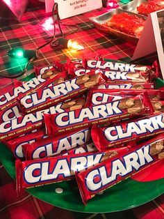 a table topped with lots of candy bar wrappers on top of a green plate