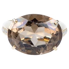 18 carat yellow gold ring designed with 1 oval smoky quartz weighing 14.30 carats and with 12 round brillant cut diamonds weighing 0.24 carats. Quality of the diamond Color: H Clarity: SI Weight : 16.20 gr. Size: EU : 61 - SP/IT : 21 - US : 9.75 Dimensions : 1.50 x 2.00 x 0.36 cm Jewel delivered in a luxurious box with a certificate of authenticity Monte-Carlo Bijoux. Condition : Like new 18 carat gold eagle head hallmark on the jewel. Secure and express delivery within 24 to 48 hours. Gold Eagle, Gold Ring Designs, Eagle Head, Yellow Gold Ring, Monte Carlo, Smoky Quartz, Yellow Gold Rings, Cocktail Rings, Diamond Rings