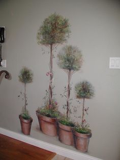 there is a wall mural with potted plants on it