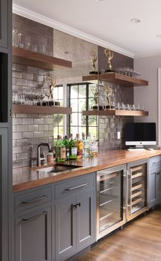 a kitchen filled with lots of counter top space next to a tv mounted on a wall