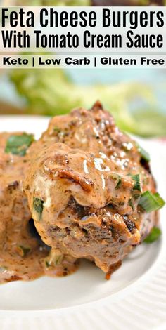 a white plate topped with meat covered in gravy