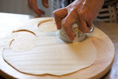 a person using a stamper on a wooden board