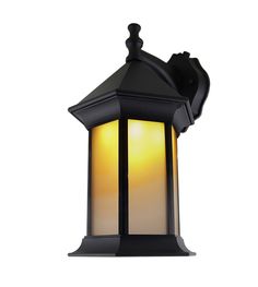 an outdoor light that is on the side of a white wall with a black roof