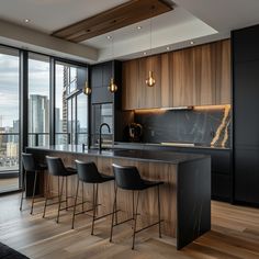 a kitchen with an island and bar stools in front of the window overlooking the city