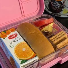 an open lunch box with sandwich, crackers and orange slices in it on a table