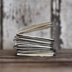 a stack of books sitting on top of a wooden table