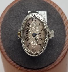 Vintage 18K White Gold Swiss Watch Filigree Ring, Size 4.25, Damaged. Hour hand is partially broken off, crystal has a chip on the side. Ring is stamped BET AIS 18K Pat. Pend. inside band. Watch movement with, 15 Jewels, 3 Adj., Elem. W. Co. Swiss. Watch does not work, balance wheel spins freely but crown won't wind. Back of ring engraved, Bob to Ruth. Ring is 24mm wide. Weighs 3.3 dwt. Are these stones real or fake? Aside from diamonds, we do not know if any gemstones are natural or synthetic. We will state on certain gemstones, that we know 100%, if they are created or fake due to their lack of inclusions. For this reason, we do not sell any diamonds without inclusions, and the larger diamonds (half ct+) are soft graded. In recent years, synthetic gemstones are being created to pass the Work Balance, Balance Wheel, European Jewelry, Vintage Fine Jewelry, Swiss Watch, Midi Rings, Filigree Ring, Watch Movement, Dream Jewelry