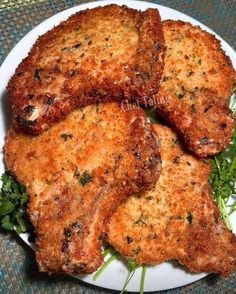 four pieces of fried meat on a white plate