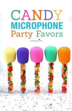 candy - filled microphones are lined up in front of a poster