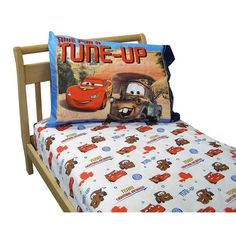 the bed is made up with cars sheets and pillows