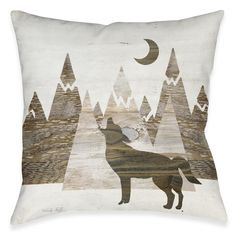 a white pillow with a wolf on it's back and mountains in the background