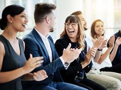 a group of people clapping and laughing together