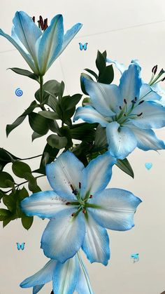 blue flowers in a vase with butterflies flying around