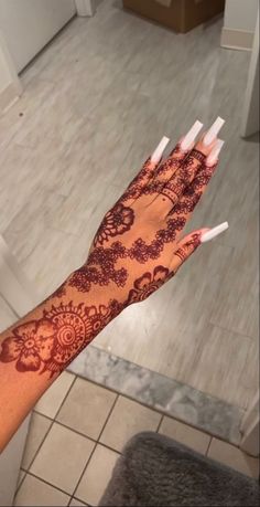 a woman's hand with henna on it