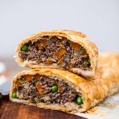 two pastries with meat, peas and carrots