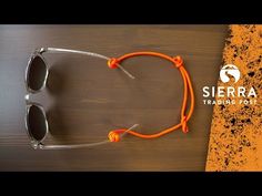 an orange pair of sunglasses sitting on top of a wooden table with the words sierra training point