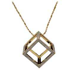 Presenting a masterfully crafted piece of artistry, features a captivating geometric pendant that exudes modern elegance. The luxurious pendant boasts a sleek gold finish, forming an open cube shape that makes a bold statement. Adorning the edges of this contemporary design is a meticulously arranged pavé of sparkling diamonds, providing a striking contrast against the polished gold surface. It's a versatile accessory, perfect for adding a touch of glamour to any ensemble, and is sure to be a treasured addition to any jewelry collection. This pendant is not just an accessory; it is a wearable piece of modern art that speaks to those who dare to stand out. THE STONES- This necklace consists of a round diamond weighing 1.625 carats. There are 336 pieces of round diamonds. The diamonds are of Contemporary Rectangular Gold Jewelry, Modern Yellow Gold Square Pendant Jewelry, Modern Diamond Cut Square Pendant Necklace, Modern Square Pendant Necklace With Diamond Cut, Modern Square Pendant Jewelry With Diamond Cut, Modern Gold Square Pendant Jewelry, Modern Gold Necklace With Square Pendant, Cube Pendant, Open Cube