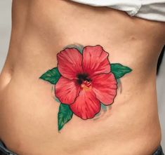 a woman's stomach with a flower tattoo on it