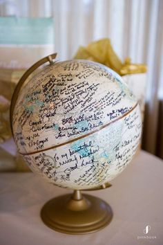 a globe with writing on it sitting on top of a table