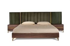 a bed with green velvet upholstered headboard and two pillows on the side