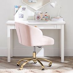 a white desk with a pink chair in front of it and a mirror on the wall