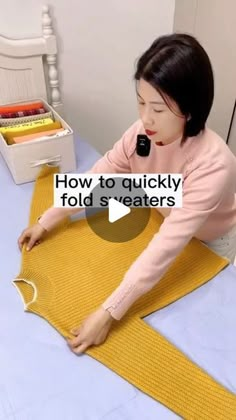 a woman in pink shirt laying on top of a bed next to a yellow blanket