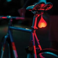 a close up of a bicycle with a red light on it