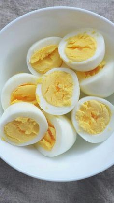 hard boiled eggs in a white bowl on a table