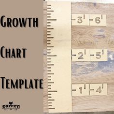 the growth chart is displayed on top of a wooden board with rulers and numbers in it