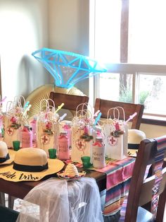 the table is set up for a party with hats and bags on top of it