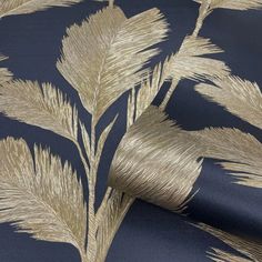 a blue and gold wallpaper with metallic leaves on it