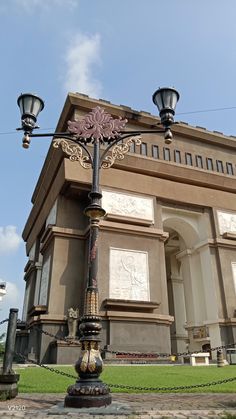 an ornate lamp post in front of a building