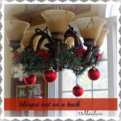 a chandelier with ornaments hanging from it's sides in front of a window