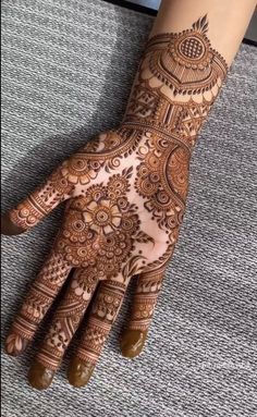 henna tattoo on the palm of someone's hand