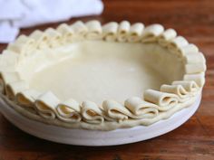 an uncooked pie sitting on top of a wooden table