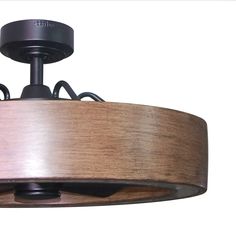 a close up of a light fixture with wood grain on the bottom and metal accents