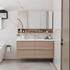 a bathroom with a toilet, sink and mirror in it's center piece is shown