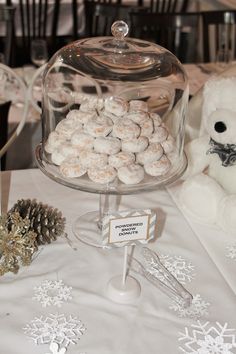 a table topped with a cake covered in white frosting next to a teddy bear