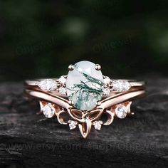 a close up of a ring with a stone in the middle and diamonds around it