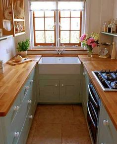 a kitchen with blue cabinets and wooden counter tops