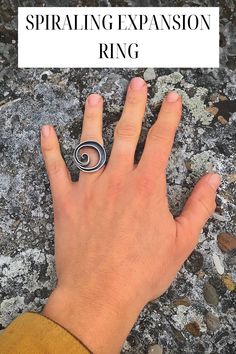 A hand wearing a large spiral ring with the negative space a see through cut out that reveals the finger below. Change Of Life, Spiral Jewelry, Cultures Around The World, Cosmic Art, Jewelry Artist, Spiral Ring, Big Rings