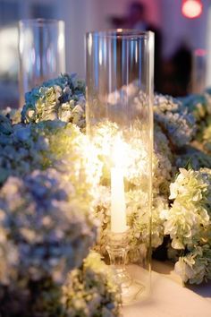 flowers and candles are arranged on a table